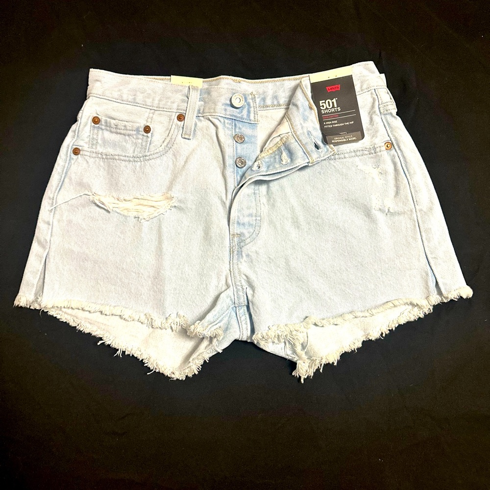 Levi’s 501 button fly distressed denim shorts in faded blue Raw Hem High Rise